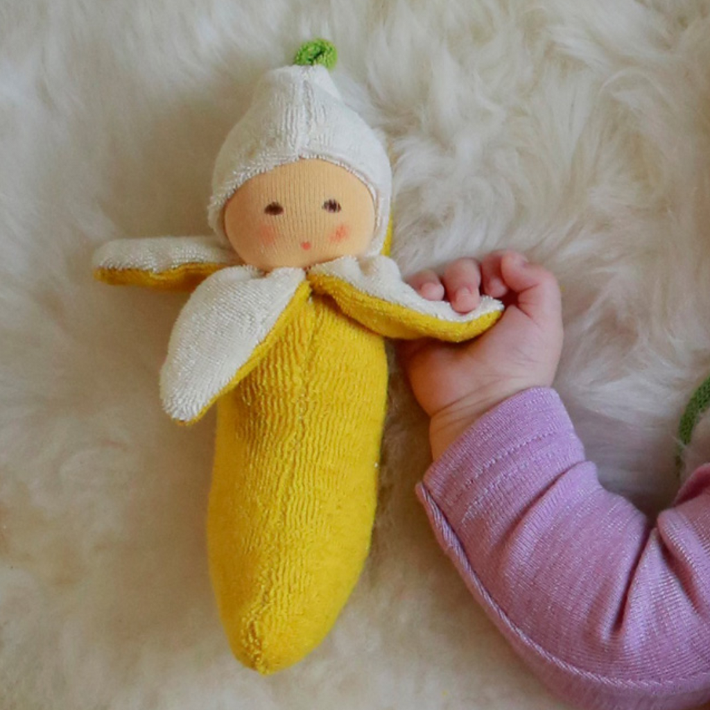 
The cutest banana ever! Sweet and charming... fresh from the tree, this little rattle is perfect for baby. Lovingly handmade to be just right for little hands to grasp, hold and love. Wonderfully charming and adorable to look at, the subtle expression is calming and comforting. A friend to have along anytime or a adorable gift!

Organic Cotton and Organic Wool
