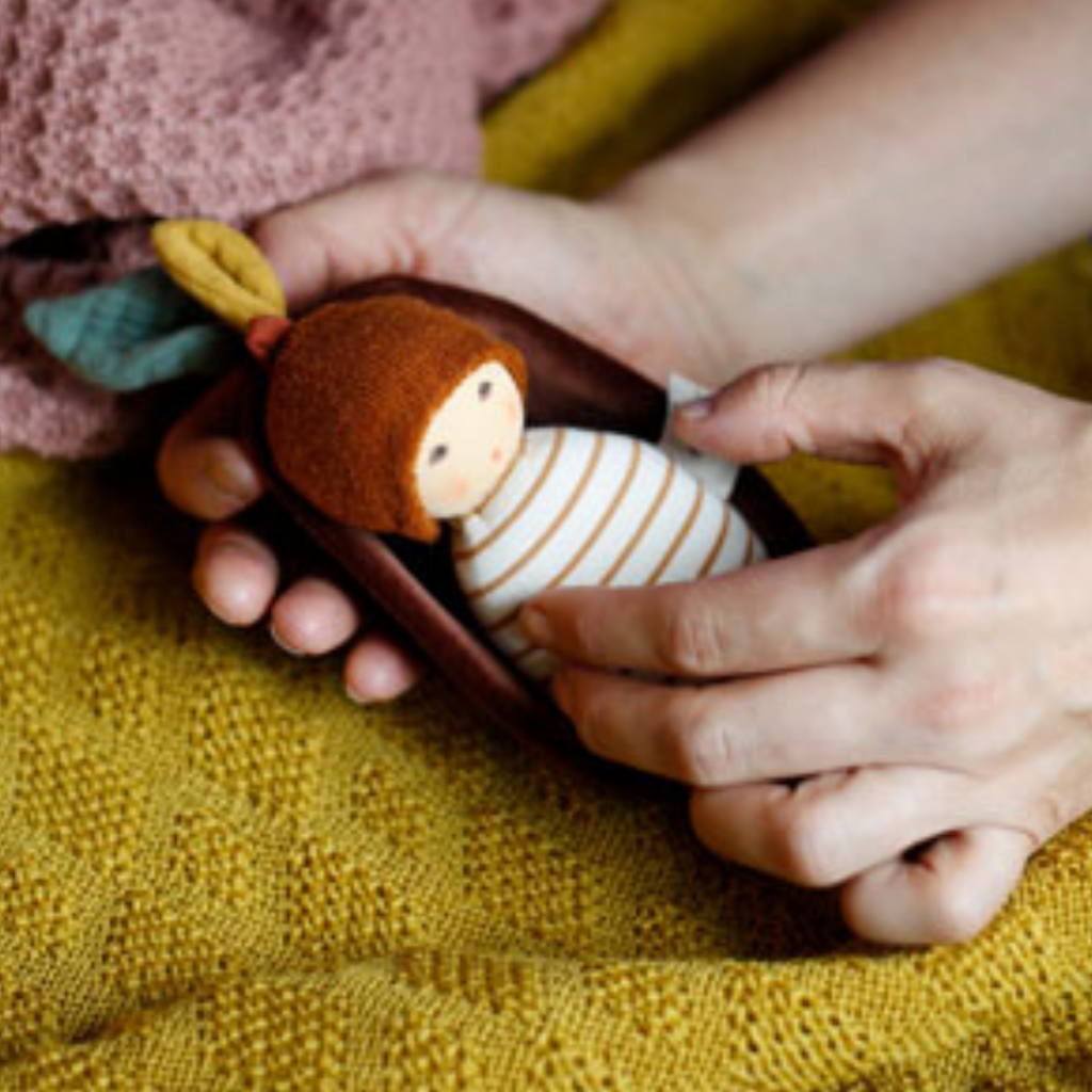 Oak Baby - Nanchen Natur This is the cutest little baby ever! Lovingly handmade for tiny hands to hold and love with a sweet, subtle expression to calm and soothe baby. A charming naptime or anytime friend at home or on the go.  Organic Rattle and lovie from Nanchen Natur
